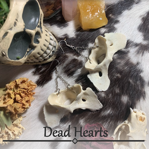 Photo of bone earrings with words "Dead Hearts" at bottom
