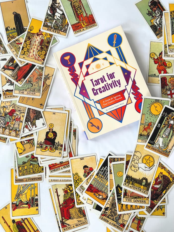 Tarot cards spread around a book titled Tarot for Creativity