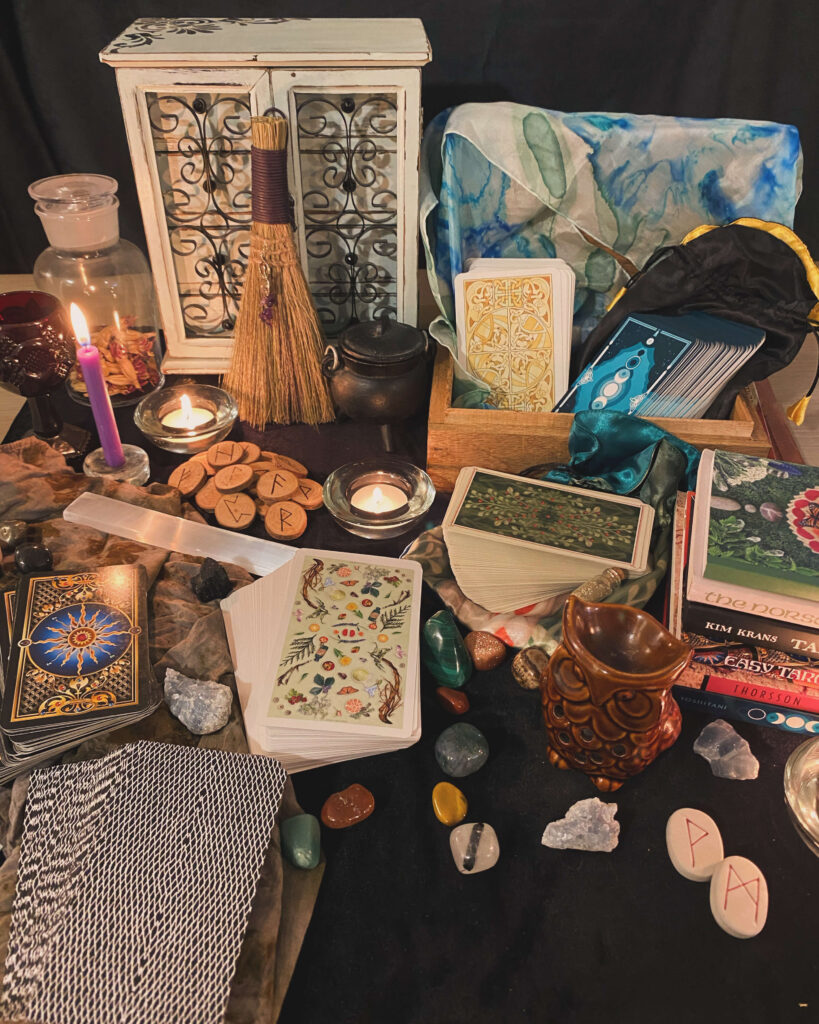 A table willed with tarot decks and round gemstones.