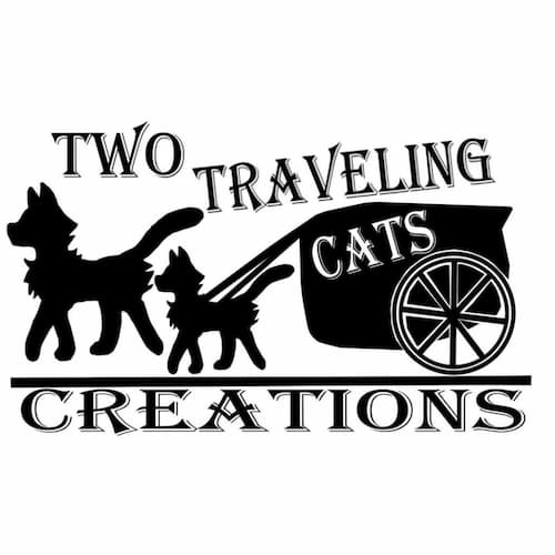 Two Travelin Cats logo: simple illustration of cats walking, with one pulling a wagon.